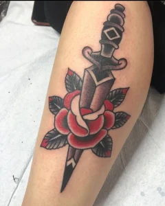 Traditional eagle tattoo with bold black and orange shading on forearm by San Diego tattoo artist